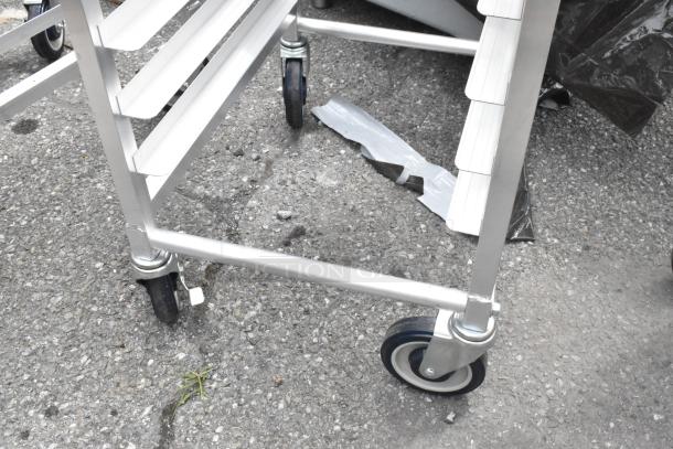 BRAND NEW SCRATCH AND DENT Regency 600STPR20KD 20 Pan Aluminum Steam Table Pan Rack with commercial casters.
