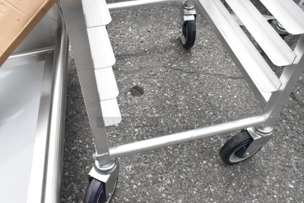 BRAND NEW Regency 600STPR20KD 20 Pan Aluminum Steam Table Pan Rack with commercial casters, scratch and dent condition.