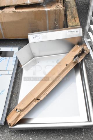 Brand new Regency 600CDT24R 16 gauge 2' clean dish table with right drainboard, slight packaging damage visible.