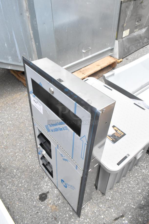 Brand new stainless steel toilet paper dispenser, scratch and dent condition, includes protective film and product labeling.