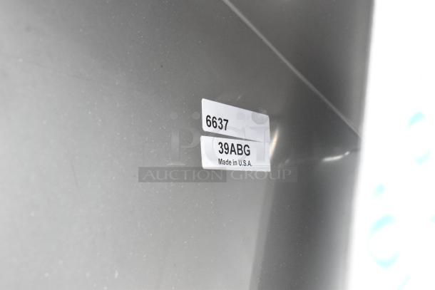 Stainless steel toilet paper dispenser, brand new condition, minor scratches, labeled "6637 39ABG Made in U.S.A."