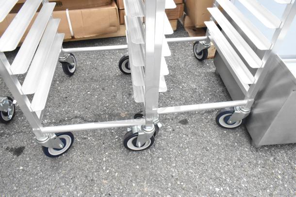 2 new Regency 600STPR20KD aluminum steam table pan racks, 20-pan capacity, on commercial casters, scratch and dent.
