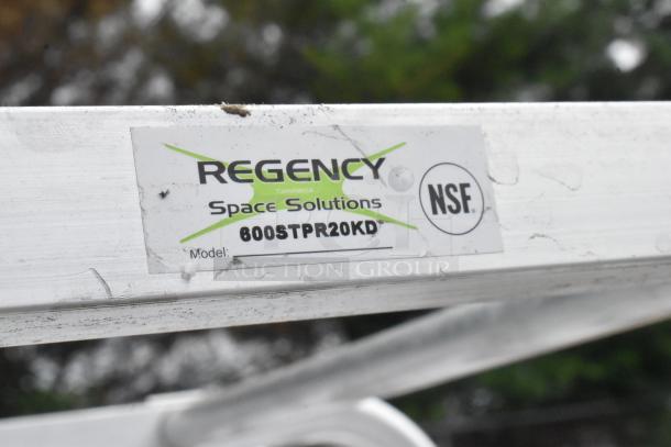 Regency 600STPR20KD 20-pan aluminum steam table pan rack, new, with commercial casters. Label indicates NSF compliance.