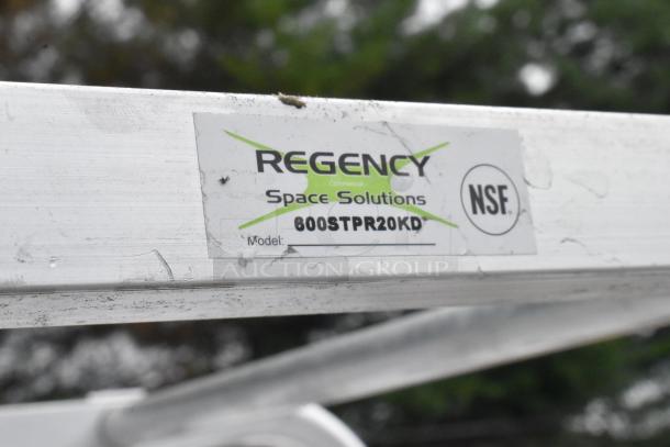 Brand new Regency 600STPR20KD 20 pan aluminum steam table pan rack with visible label, NSF-certified, on commercial casters.