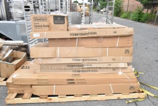 Stack of boxed items including Steelton Speed Rail, Regency Pan Rack, and Cambro Shelving kits, all new and labeled.
