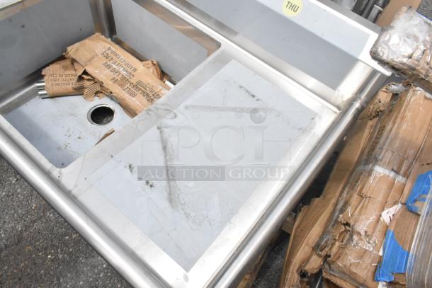 Regency 600S12424218 stainless steel single bay sink with dual drain boards, scratch and dent condition, visible packaging.