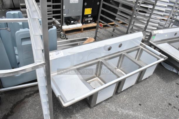 Stainless steel Regency 600S3151515L 3 bay sink with left side drain board; new, scratch and dent condition.