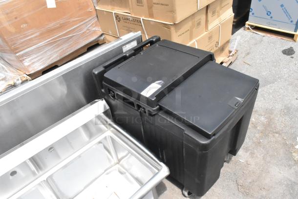 Brand new Cambro black poly insulated portable ice bin on commercial casters. Scratch and dent condition.