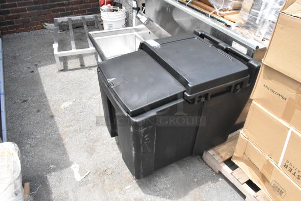 Brand new Cambro black poly insulated ice bin on commercial casters, slight scratches, ideal for portable use.