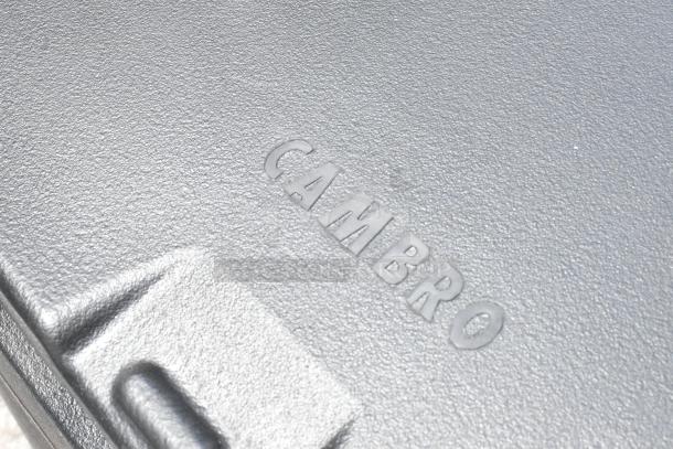 Cambro black poly insulated ice bin with commercial casters; brand new, minor scratches and dents visible.