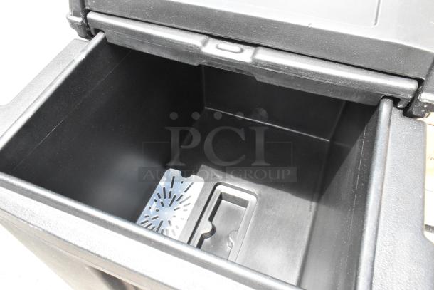 Black Cambro poly insulated portable ice bin, brand new with minor scratches, featuring commercial casters for mobility.