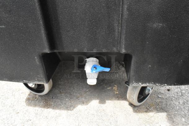 BRAND NEW Cambro black poly insulated ice bin on commercial casters, visible blue valve, minor scratches, heavy-duty design.