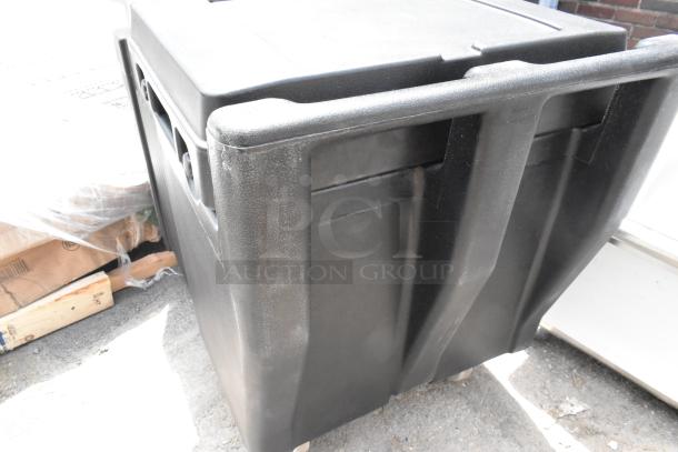 BRAND NEW Cambro black poly insulated portable ice bin on commercial casters. Scratch and dent condition.
