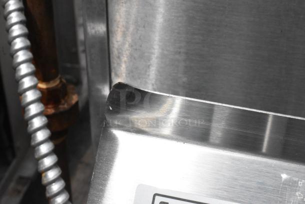 Brand new Steelton 522CS21717 18 gauge stainless steel two compartment sink corner close-up showing minor scratches.