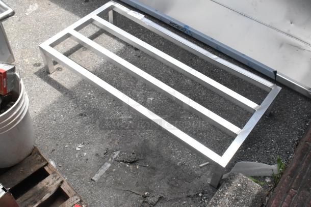 Alt text: Brand new Regency 600DUN24488 aluminum dunnage rack, 48" x 24" x 8", 1780 lb. capacity, minor scratches visible.