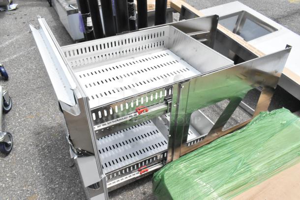 Clark stainless steel drawers, scratch and dent condition, featuring perforated shelves, visible shipping wrap and light scratches.