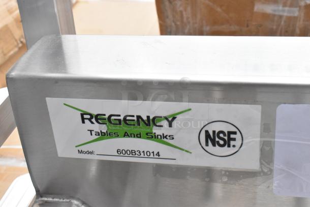 BRAND NEW Regency 600B31014 stainless steel 3 bay sink without legs. Scratch and dent condition. NSF certified label visible.