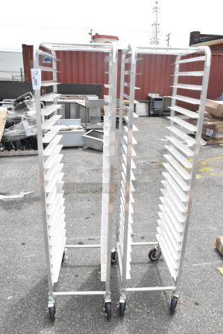 2 brand new Regency 600STPR20KD 20 pan aluminum steam table pan racks on commercial casters; slight scratches and dents.