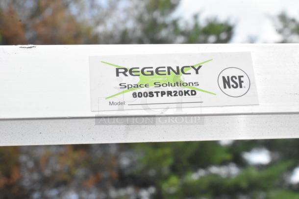 Regency 600STPR20KD steam table pan rack label, NSF approved, on aluminum frame with visible scratch.
