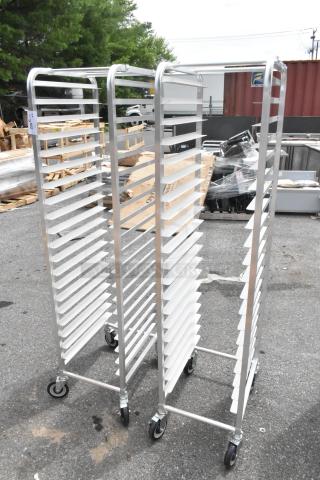 2 brand new Regency 600STPR20KD aluminum steam table pan racks with 20 slots on commercial casters, slightly scratched.