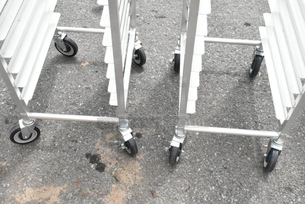 2 Brand New Regency 600STPR20KD pan racks, aluminum, 20-pan capacity, on commercial casters, scratch and dent condition.
