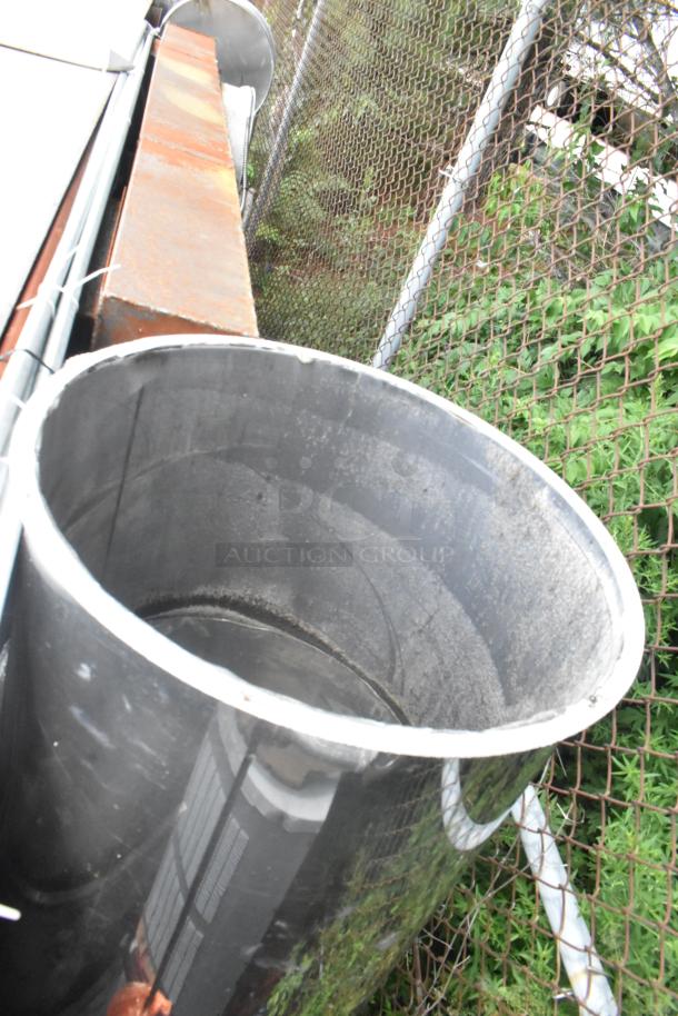 Stainless steel commercial grease hood with mushroom exhaust fan, visible rust, and FloAire SA15 filtered air vent.