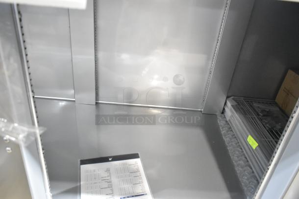 Beverage Air DP93HC stainless steel pizza prep table interior; new condition, visible shelves and packaging inside.