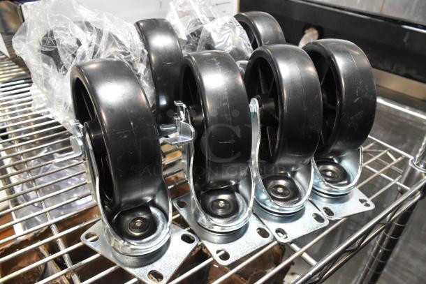 Lot of 8 brand new commercial casters, black wheels and metal mounting plates, slight scratches, still in original packaging.