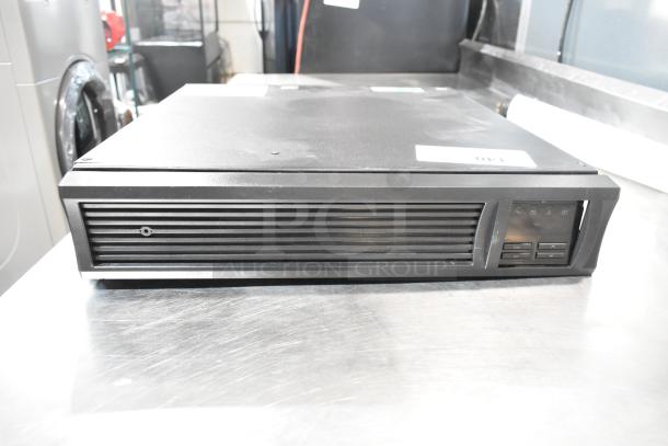 2 APC Uninterruptible Power Supplies, rack-mountable, button controls, in good condition, labeled "140" on top.