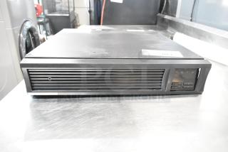2 APC Uninterruptible Power Supplies, rack-mountable, button controls, in good condition, labeled "140" on top.