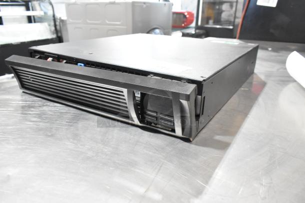 APC Uninterruptible Power Supply unit, black, rack-mount design, front panel vents, visible power connections, good condition.