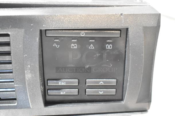 APC Uninterruptible Power Supply, black, front view showing control buttons and indicators. Good condition.