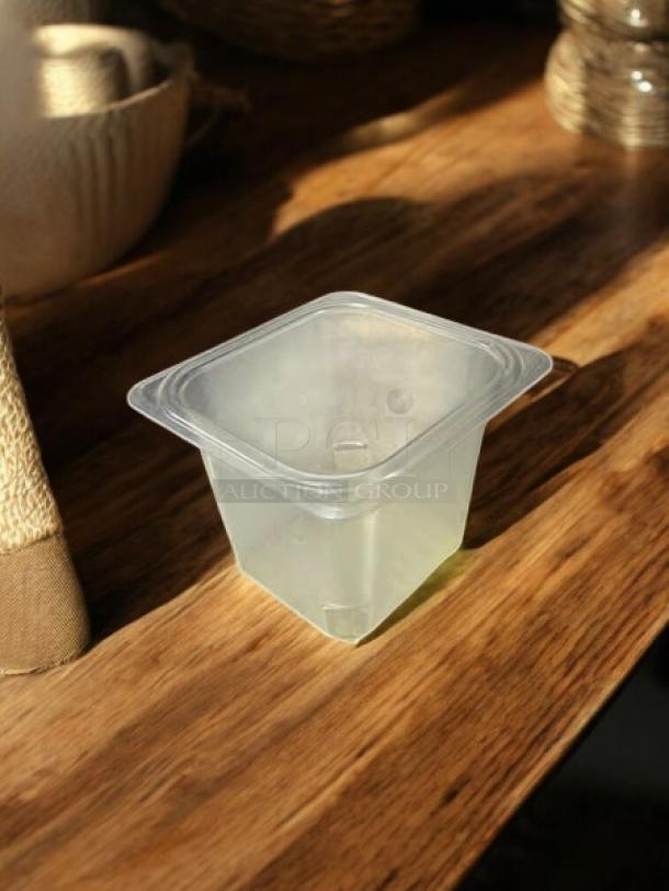 Cambro 65CLRCW135 clear polycarbonate colander pan, 1/6 size, 4" deep, great condition, shown on a wooden surface.