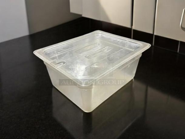 Welshine 1/2" clear food storage container with lid, in great condition, placed on black countertop.