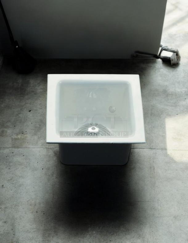 PROFLO 12" x 12" enameled cast iron floor sink, model PF906K, with aluminum strainer; excellent condition.