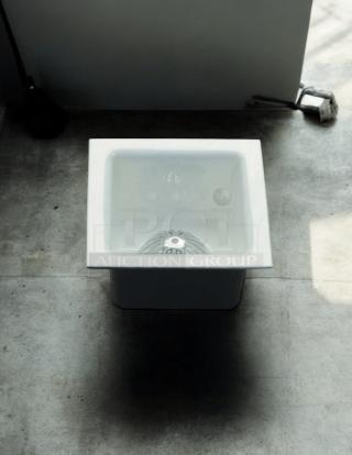 PROFLO 12" x 12" enameled cast iron floor sink, model PF906K, with aluminum strainer; excellent condition.