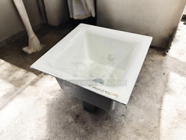 Proflo 12" x 12" enameled cast iron floor sink, model pf906k, in excellent condition, with aluminum strainer.