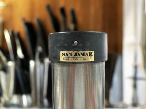 San Jamar C3400P stainless steel cup dispenser, wall mount, pull-type, holds 12-24 oz cups, excellent condition, labeled.