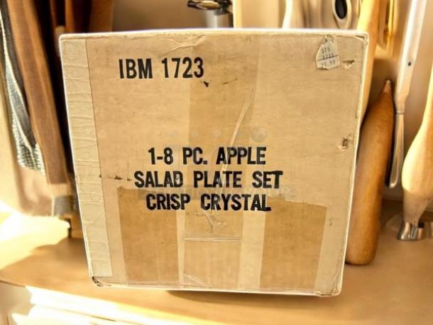 Cardboard box labeled "IBM 1723" containing 1-8 piece Apple salad plate set, Crisp Crystal, in excellent condition.