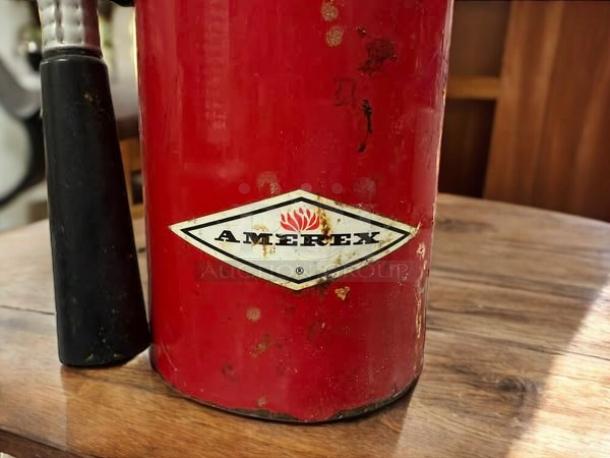AMEREX Model A500 dry chemical fire extinguisher with visible wear; red body, logo present; condition suggests prior use.