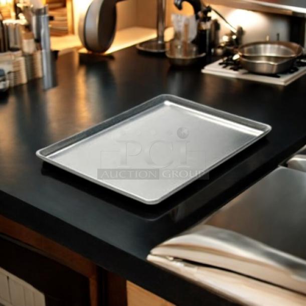 Half size 13x18x1" bakery sheet pan in excellent condition on a kitchen counter. Durable material, smooth surface.