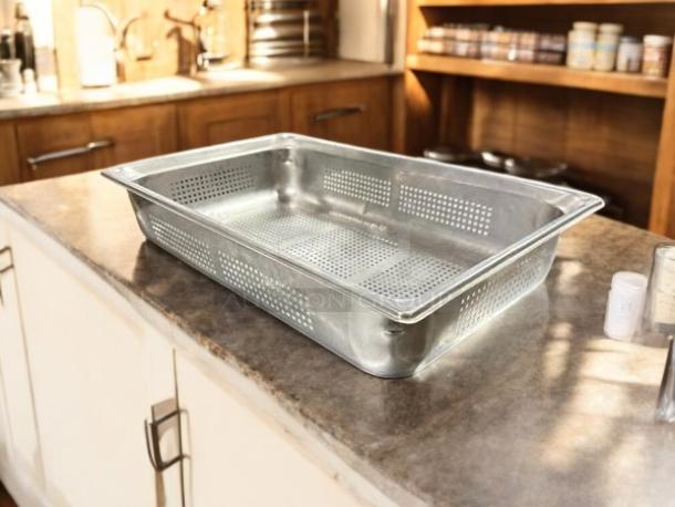 Full-size 4" deep stainless steel hotel pan strainer with lid, in excellent condition, perforated sides and base.