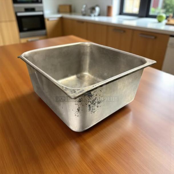 Stainless steel hotel pan, 1/2 size, 6" deep, in great condition with minor surface wear, ideal for commercial kitchen use.