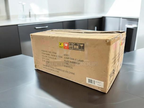 Box containing Zuni Mod Jump Table Lamp. Item number 53001. Color: Rust & Amber. Weight: 5.44 kg. Made in China.