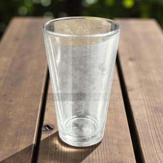 12 oz glass drinking cup in excellent condition, clear with slight reflections, shown on a wooden table.