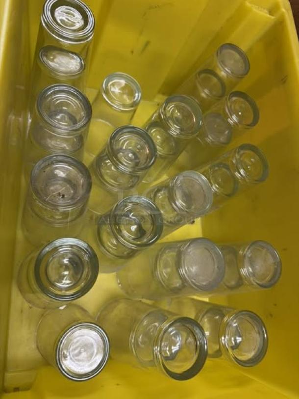 12 oz glass drinking cups in excellent condition, arranged in a yellow container. Clean and clear, ideal for beverages.