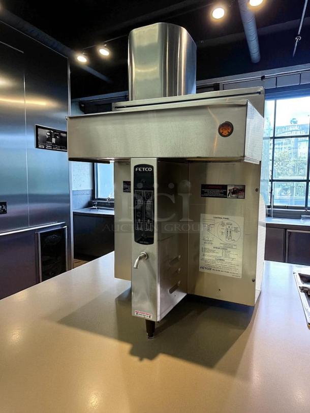 Fetco CBS-2032E twin coffee brewer in excellent condition, stainless steel finish, clear control panel labeling, 240v, fully tested.