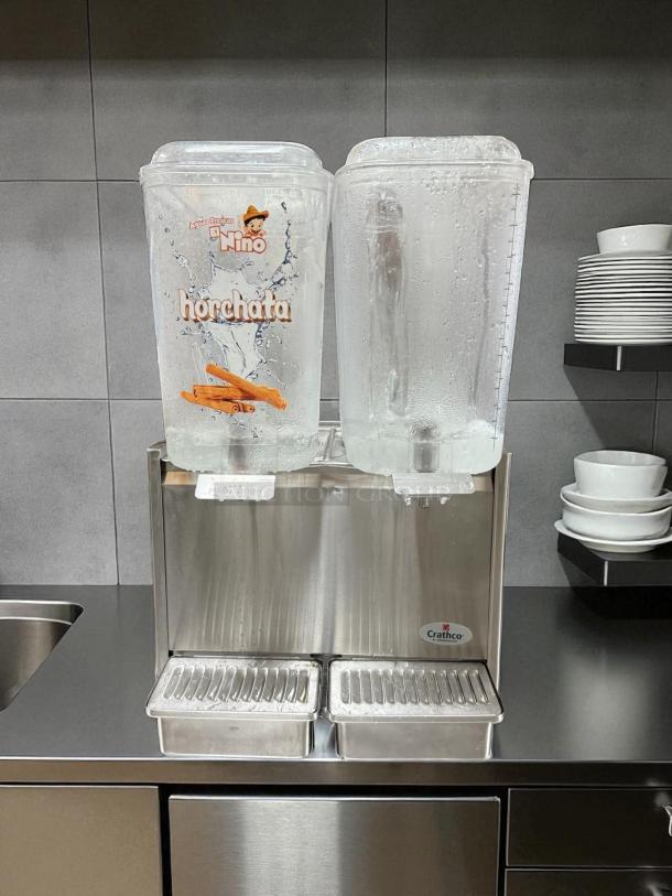 Crathco D25-3 beverage dispenser with double 5-gallon bowls, stainless steel, "horchata" label, used condition.