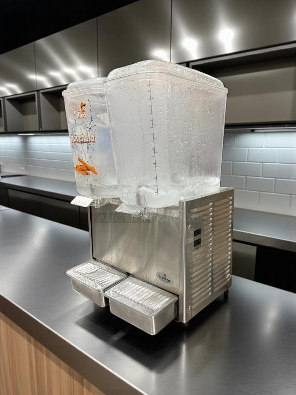 Crathco D25-3 beverage dispenser, stainless steel, double 5-gallon bowls, refrigerated, clean, with measurement markings.