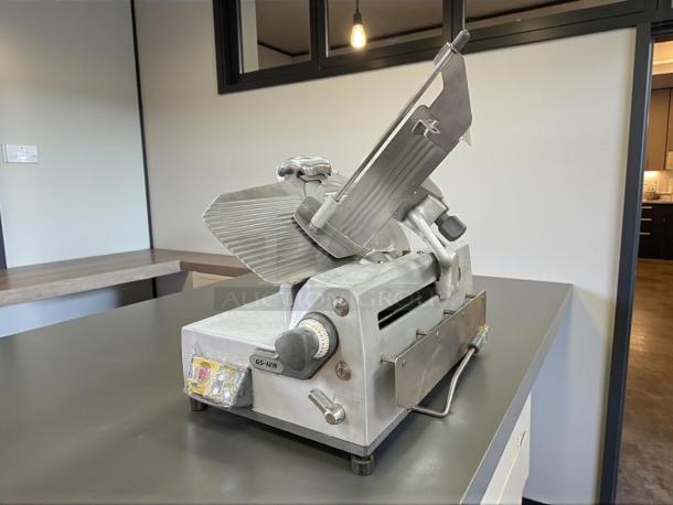 Heavy-duty German Knife GS-12A food slicer by Turbo Air, showing blade and adjustment knobs. Tested, working, 115v, durable design.